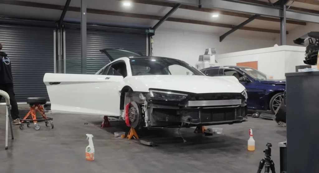 Mat Armstrong watches as a vibrant pink car wrap transforms a white vehicle during an intense 13-hour session inside his workshop to meet a midnight deadline