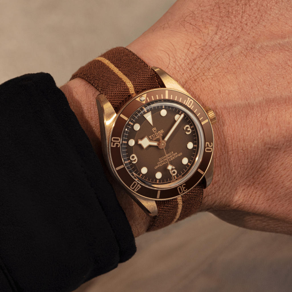 A Tudor watch with a brown and gold band.