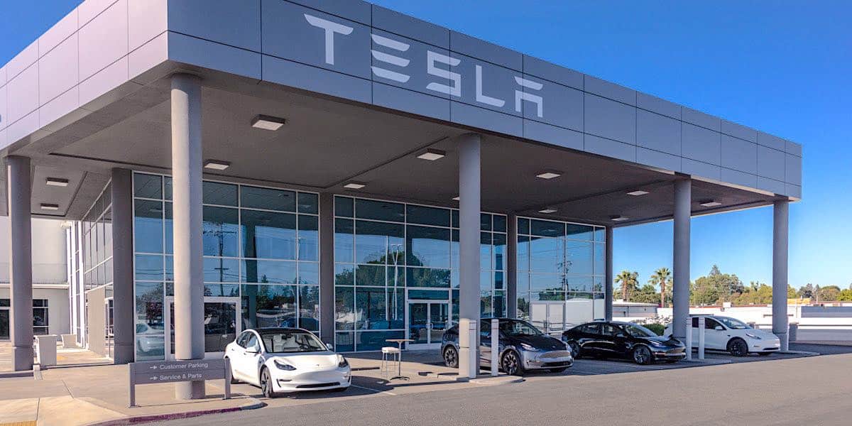 Tesla vehicles parked outside of a service center