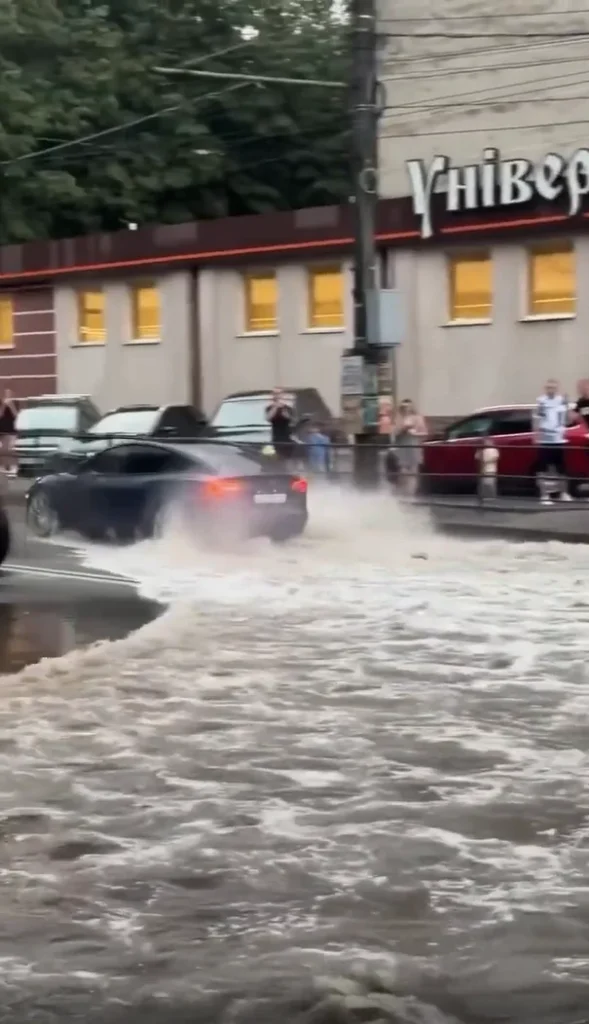 Tesla Model 3 spotted driving through a completely flooded street and it's definitely not something you'd see every day