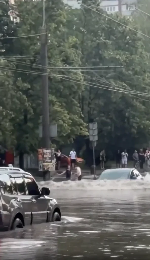 Tesla Model 3 spotted driving through a completely flooded street and it's definitely not something you'd see every day