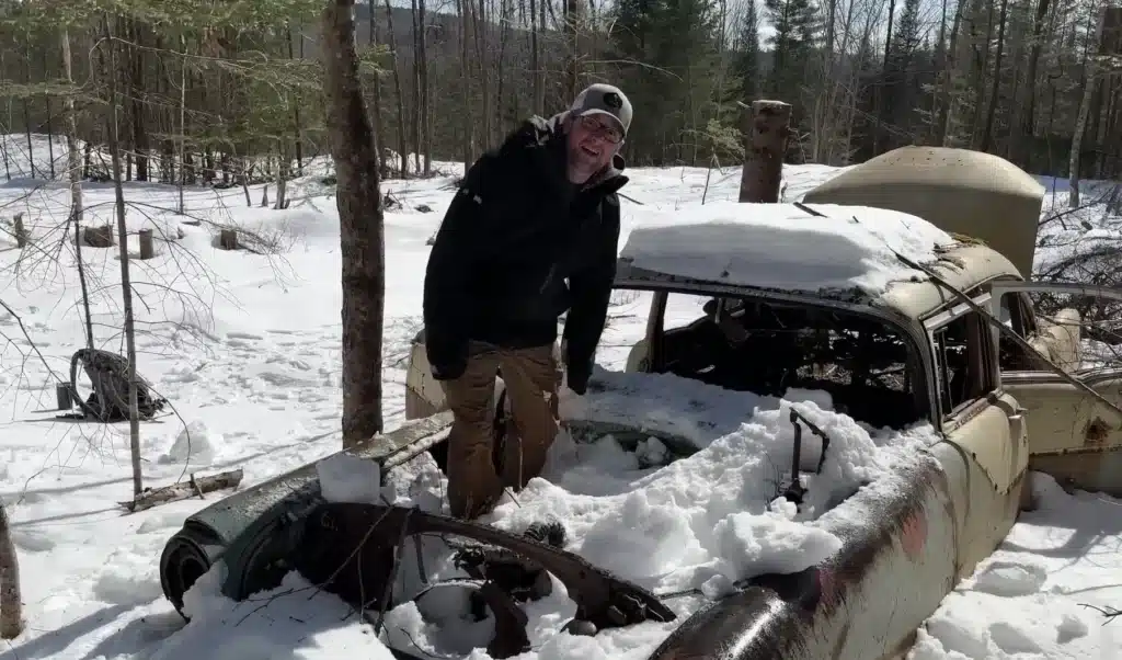 Abandoned car covered in snow