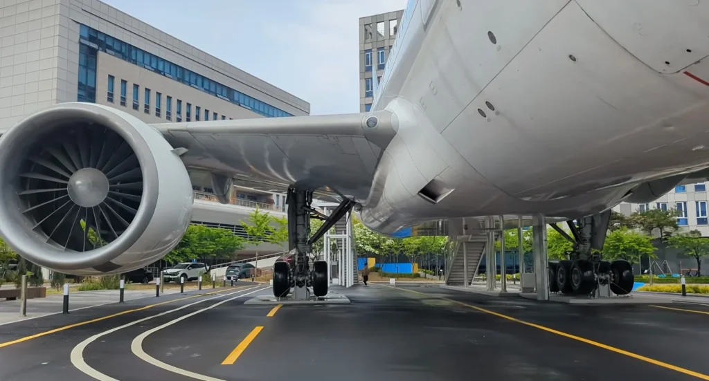 There is a Boeing 777-200ER parked right next to a soccer field on a university campus in South Korea, and there are two reasons why that's the case