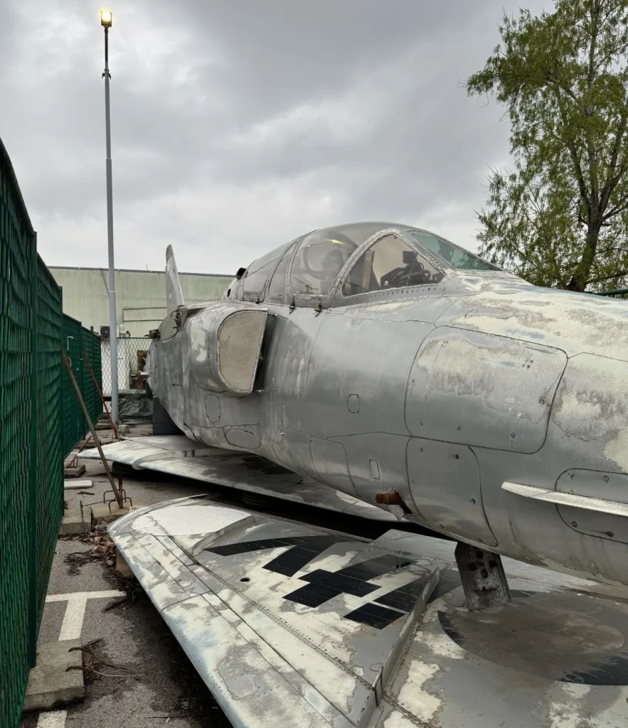 fighter Jet parked near industrial and residential buildings in Europe