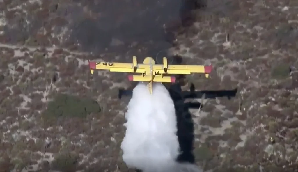 This Canadair CL-415 Super Scooper was spotted lifting off in New Mexico just inches away from the lake beach after scooping water on board until the last second