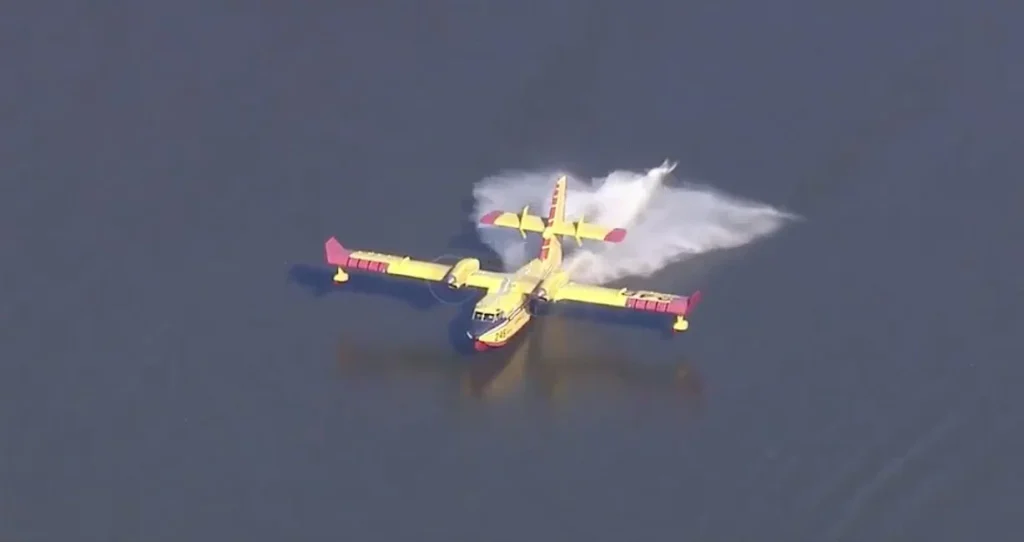 This Canadair CL-415 Super Scooper was spotted lifting off in New Mexico just inches away from the lake beach after scooping water on board until the last second