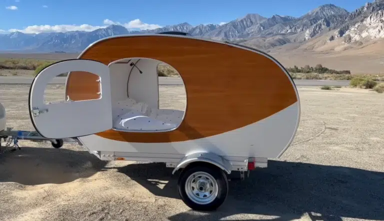 This DIY camper build features a teardrop camper on a custom trailer, completed in just three weeks using CAD tools and lightweight materials