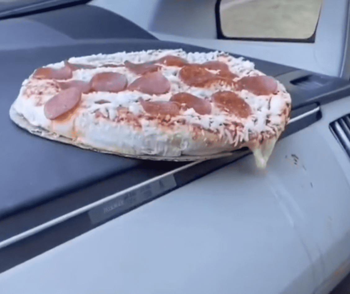 Pizza cooked on car dashboard