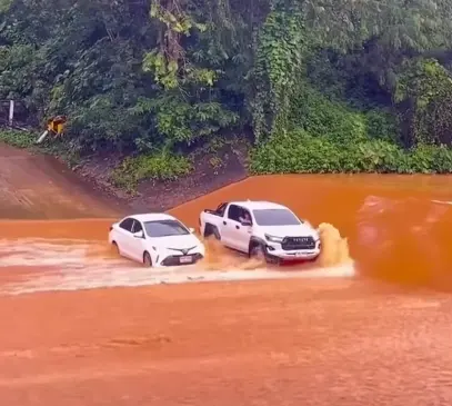 Toyota Hilux GR Sport shows off its unreal power and strength by driving alongside Toyota Corolla Altis to block it from heavy floodwaters
