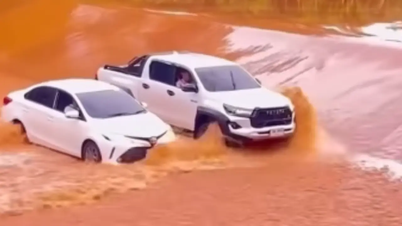 Toyota Hilux GR Sport shows off its unreal power and strength by driving alongside Toyota Corolla Altis to block it from heavy floodwaters