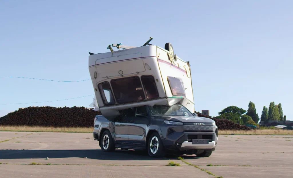 Toyota drops a caravan on an electric Hilux in a classic Top Gear throwback to see if the EV can survive