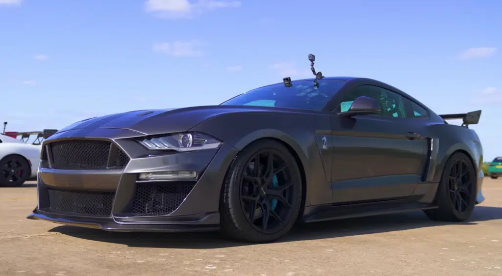 A supercharged Ford Mustang faces a Dodge Viper in a tuned V8 drag race, testing torque, weight, and real-world performance across multiple formats