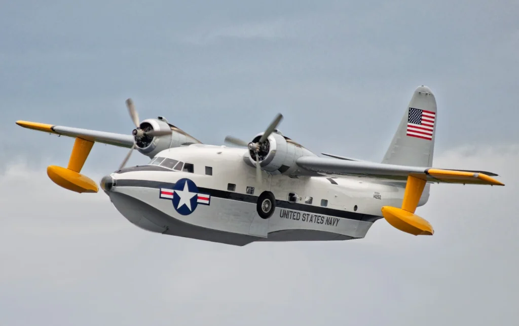 Jay Leno pops out of nose of Grumman HU-16 Albatross airplane flying over the Pacific Ocean