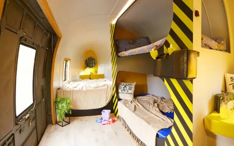 This unique vacation destination lets visitors sleep inside old rescue helicopters with original controls, in Pinewood Park, UK