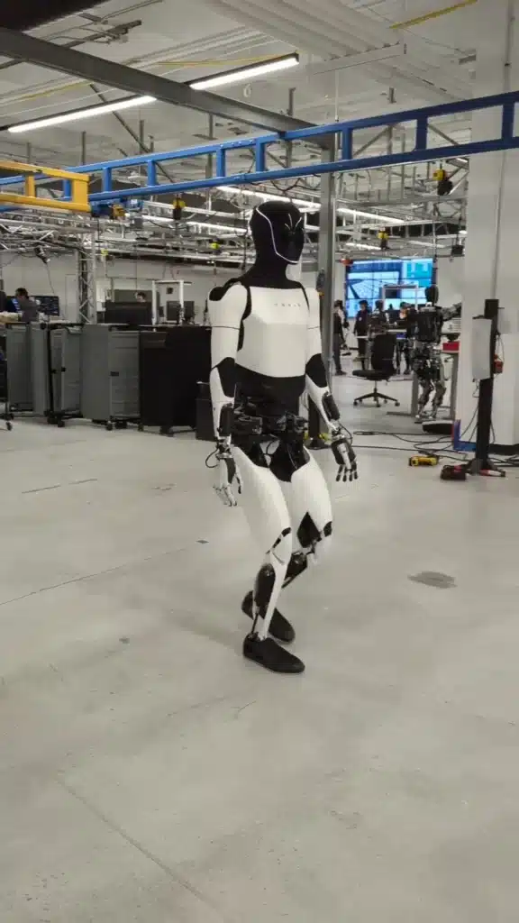 Elon Musk shares new video of Optimus tesla robot strolling confidently around lab