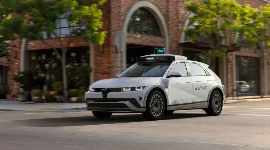Waymo veteran John Krafcik says Tesla Robotaxi is closer to ride-hailing as Elon Musk defends the service and its rollout in California