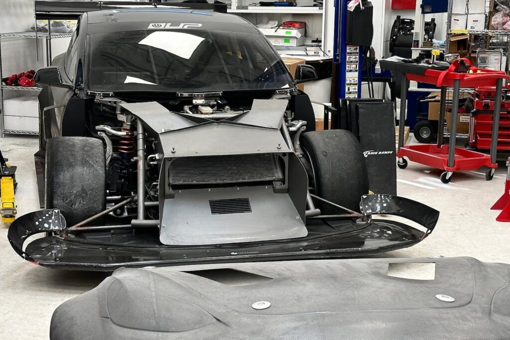 Wrecked Tesla Model 3, Bionic Phoenix inside the garage