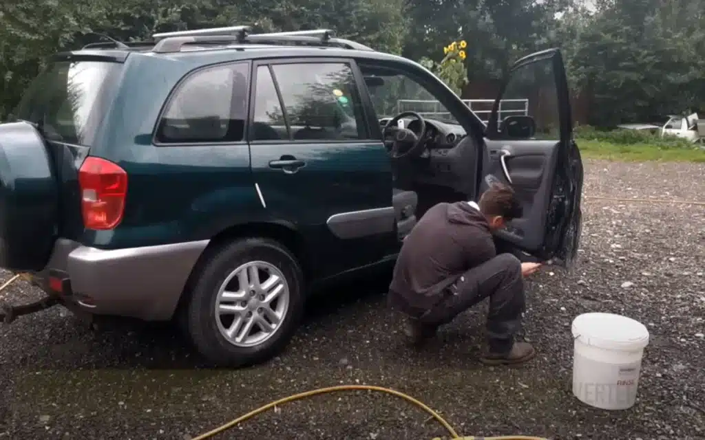 A group of used cars, including this Toyota RAV4 being fixed up before flipping for a profit