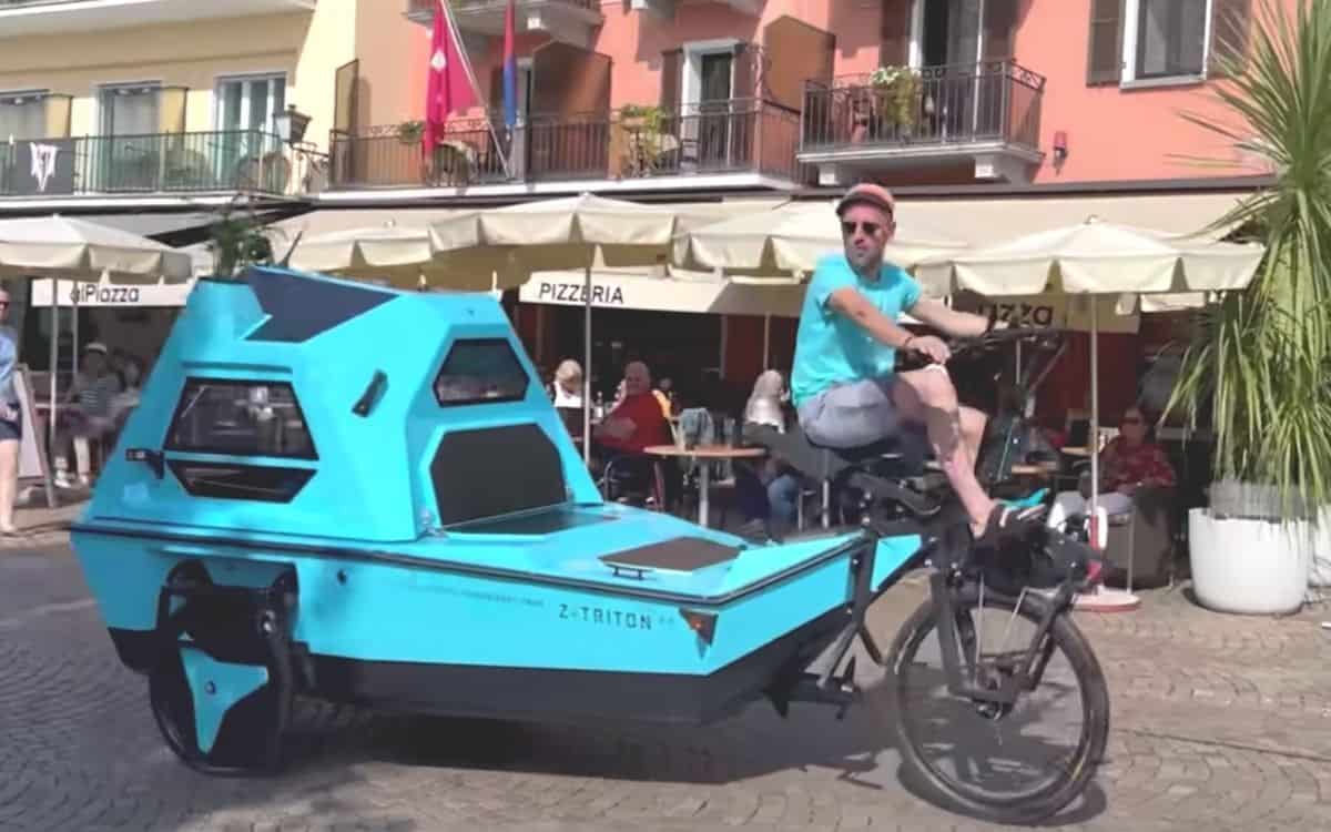 Man riding amphibious tricycle camper