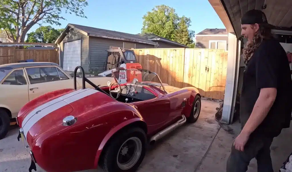 AC Cobra muscle car in a shipping container