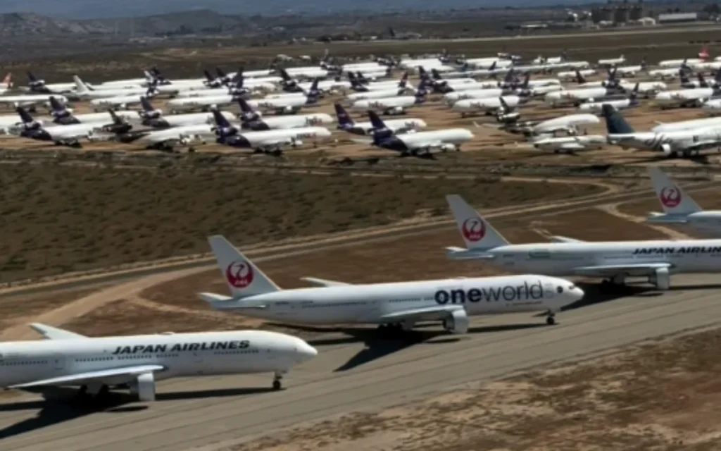 A pilot flies over Southern California Logistics Airport in Victorville, revealing the vast airplane graveyard where some jets are scrapped and others wait
