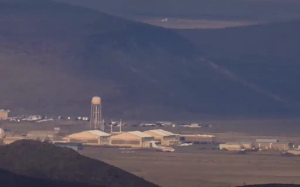 Washington YouTuber Johnny Harris road-trips to Area 51, hikes Tikaboo Peak, and captures jets, midnight runway lights, and a mystery fly-by - but no UFO