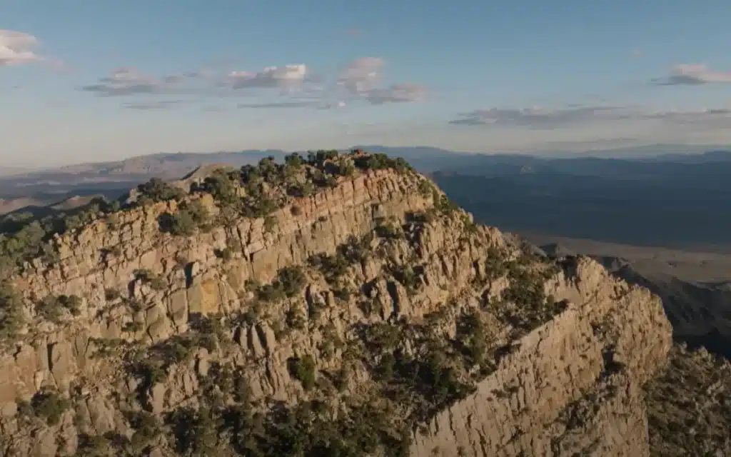 Washington YouTuber Johnny Harris road-trips to Area 51, hikes Tikaboo Peak, and captures jets, midnight runway lights, and a mystery fly-by - but no UFO