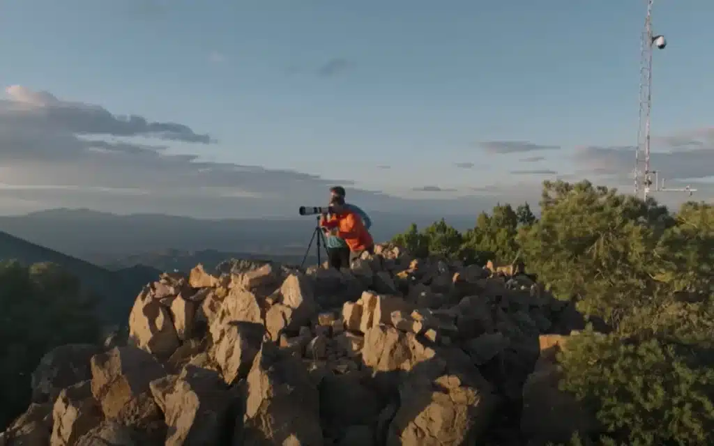 Washington YouTuber Johnny Harris road-trips to Area 51, hikes Tikaboo Peak, and captures jets, midnight runway lights, and a mystery fly-by - but no UFO