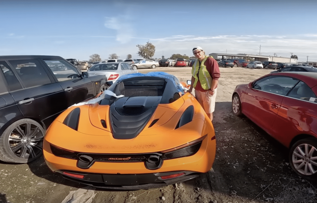 Brand new $300,000 McLaren is among junk cars despite seemingly being in mint condition