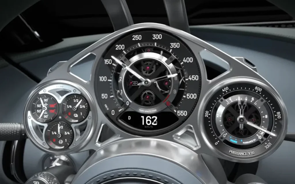The Bugatti Tourbillon gauge cluster is built like a Swiss watch, with 650+ parts, rubies, gears, and LEDs instead of a screen