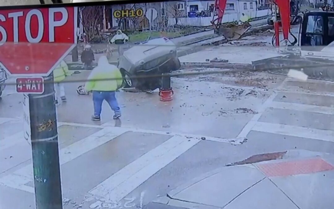 Watch this car drive straight into a construction site and into a massive hole in the ground