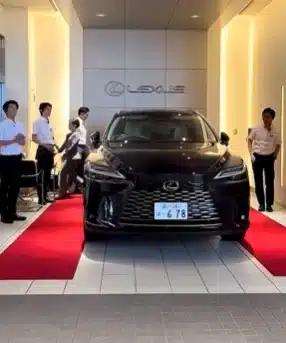 When you buy a Lexus in Japan, the delivery day plays out like a movie scene - bows, music, and a dramatic car reveal that feels more ritual than sale
