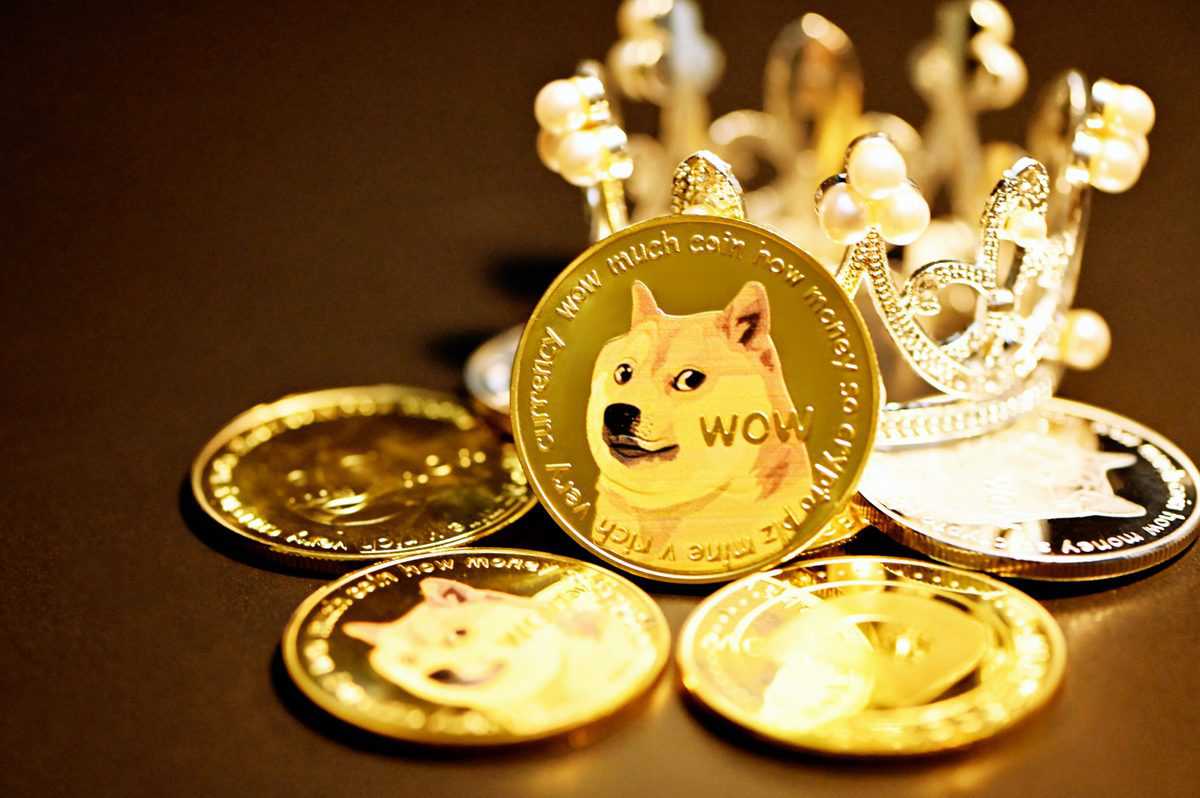 Dogecoin sits on a crown and a pile of coins.