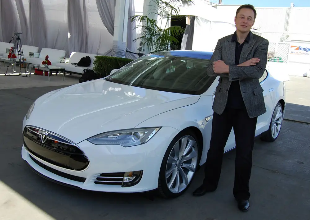 Elon Musk pictured with a Tesla Model S