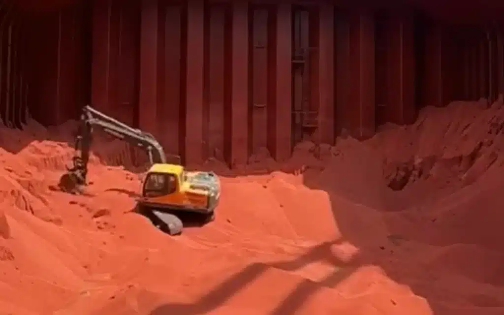 Footage showing an excavator being lowered into a cargo ship to help during the unloading process has left social media users in disbelief