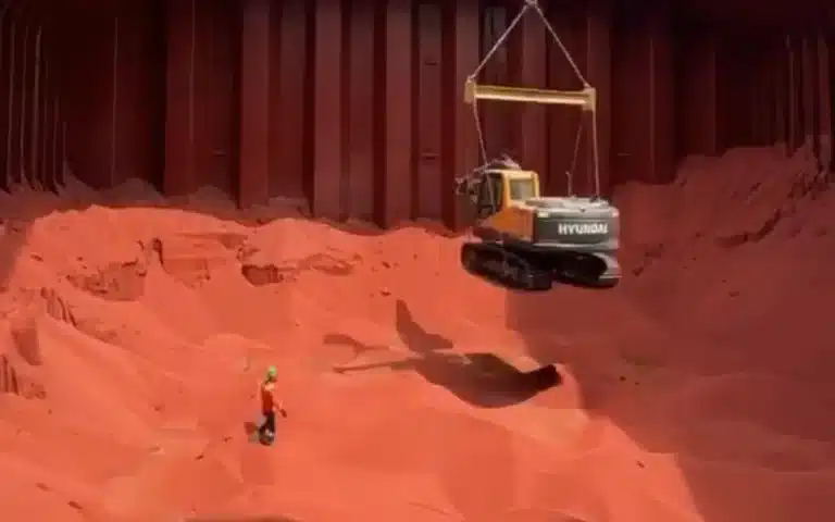Footage showing an excavator being lowered into a cargo ship to help during the unloading process has left social media users in disbelief