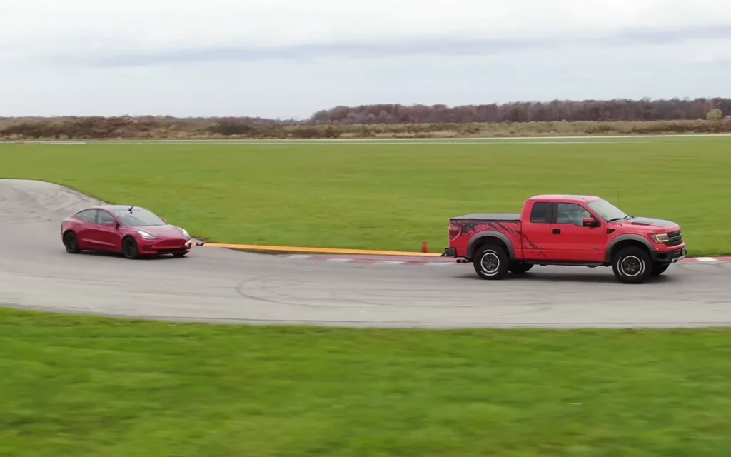 These YouTubers found that towing a Tesla Model 3 with a combustion Ford F-150 Raptor to charge its battery is more efficient than driving the truck itself