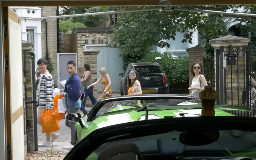 A YouTuber opens his garage to reveal a Lamborghini Huracán Performante and Ferrari 458 Speciale Aperta, sparking priceless reactions from passersby