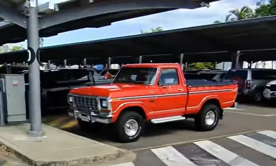 A son surprised his dad with a 1970s Ford F-150 in an emotional reveal at Townsville Airport that turned their journey home into a father-son road trip