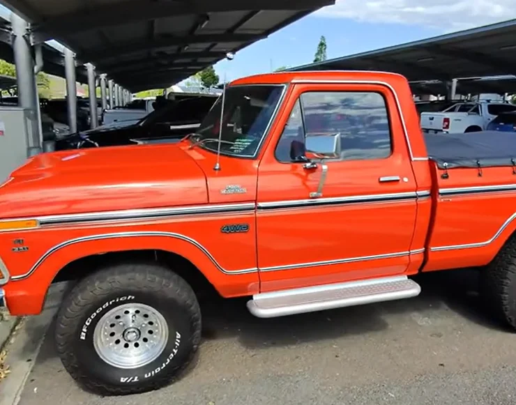 A son surprised his dad with a 1970s Ford F-150 in an emotional reveal at Townsville Airport that turned their journey home into a father-son road trip