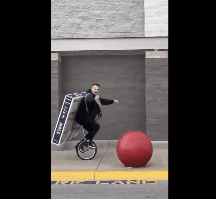 Guy transports TV using unicycle
