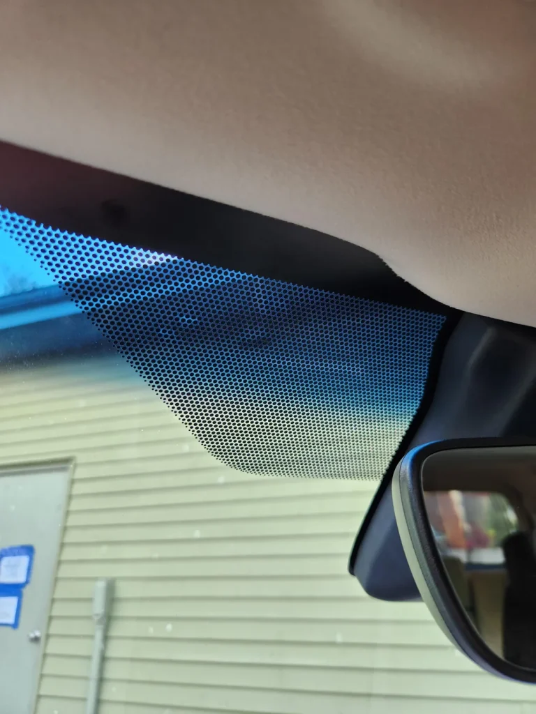If you’ve ever taken a proper look at your car’s windshield, you’ve probably noticed some small black dots around the edge, but you’ve also probably given them little thought