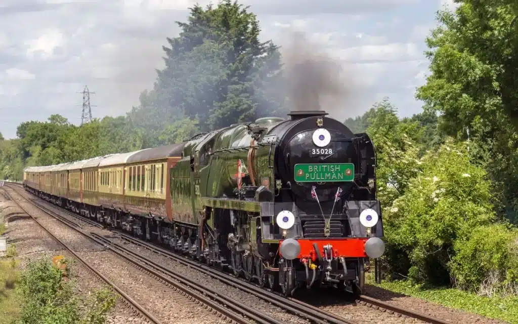 This super-luxury scenic steam train transports you right back to the roaring 20s in Britain with the Belmond British Pullman behind Merchant Navy Class loco Clan Line