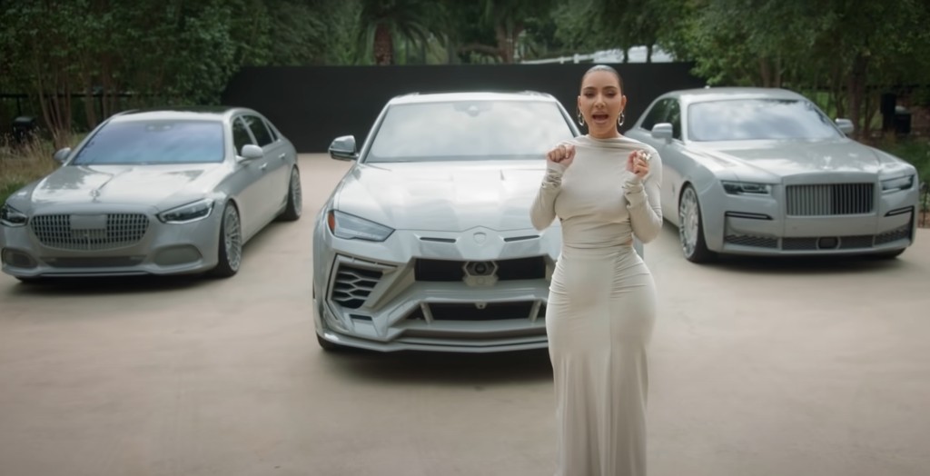 Kim Kardashian stands in front of her three cars in a Vogue video.