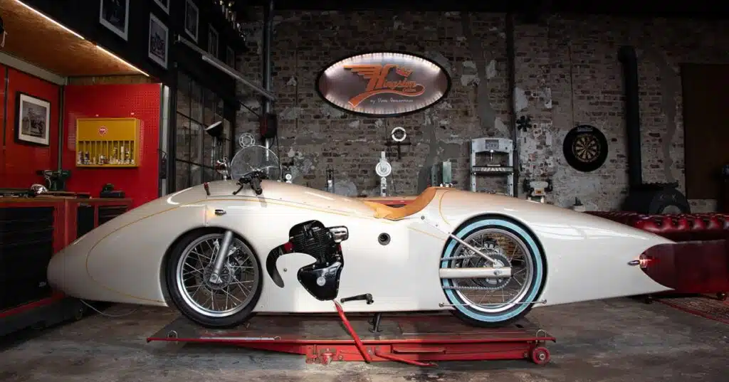 Check out this custom Kingsman Royal Enfield Shotgun 650 that’s been converted into an art deco streamliner, complete with a secret storage compartment stocked with gin