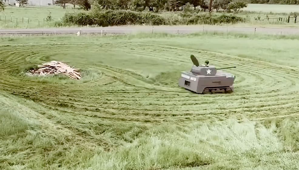 Hibbs mows his lawn in his converted lawn mower tank
