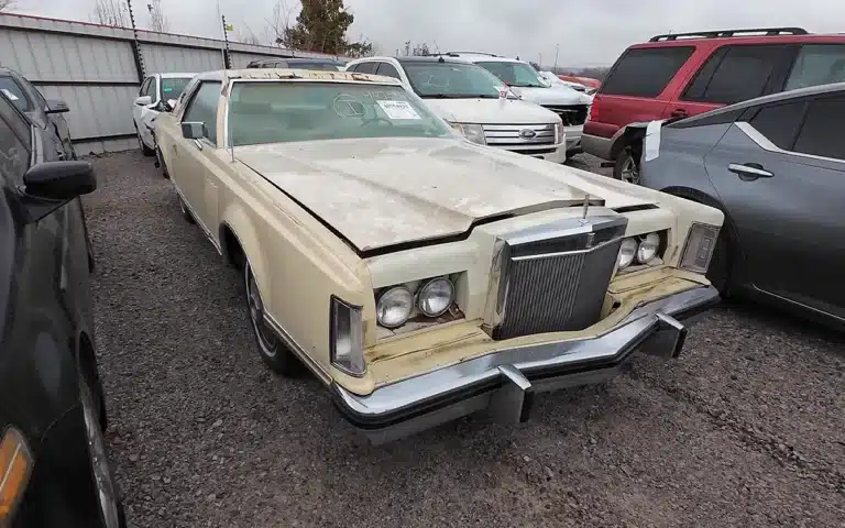 abandoned Lincoln Continental Mark V with a handwritten note