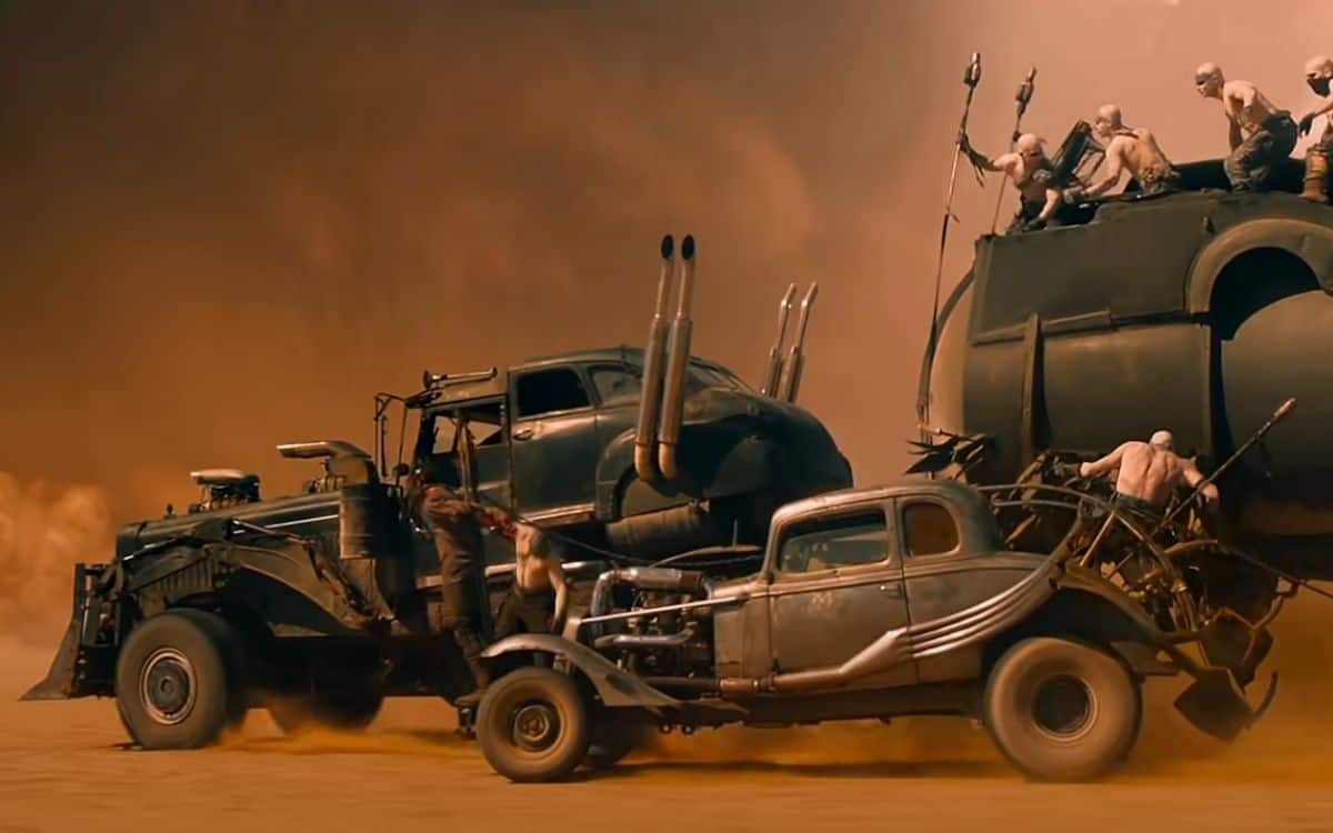 The dust storm swallows cars in Mad Max: Fury Road.