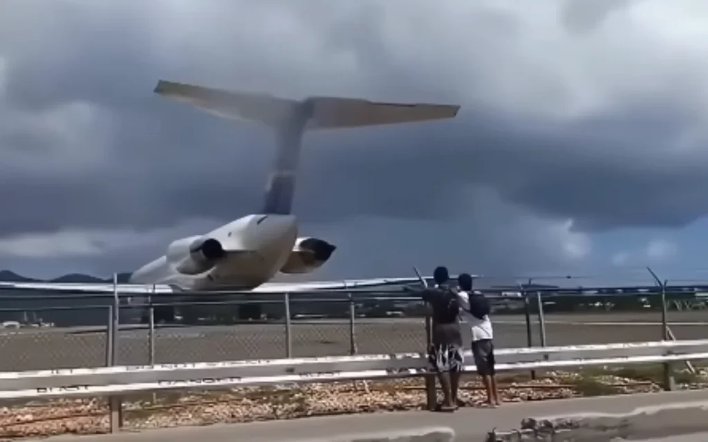 An MD-80 jet blast at Maho Beach in Sint Maarten sends tourists stumbling as engines throttle up just steps from the sand