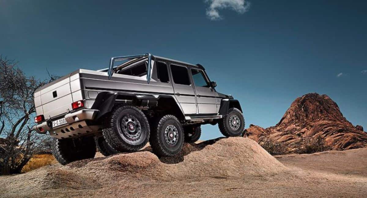 The Mercedes G 63 AMG 6X6 drives over sand.